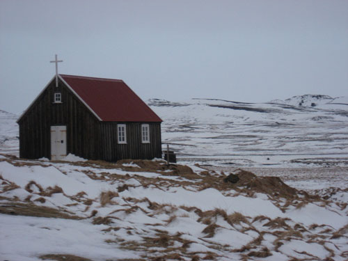 Krýsuvíkurkirkja, a church within a national park of lava fields and black cliffs in Iceland.